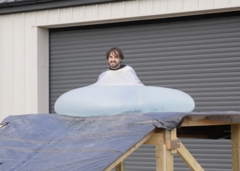 Man rolls downhill in giant water balloon in glorious slow motion