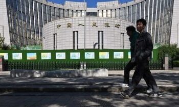 China reserve gauge hits 12-year high, smoothing yuan rise